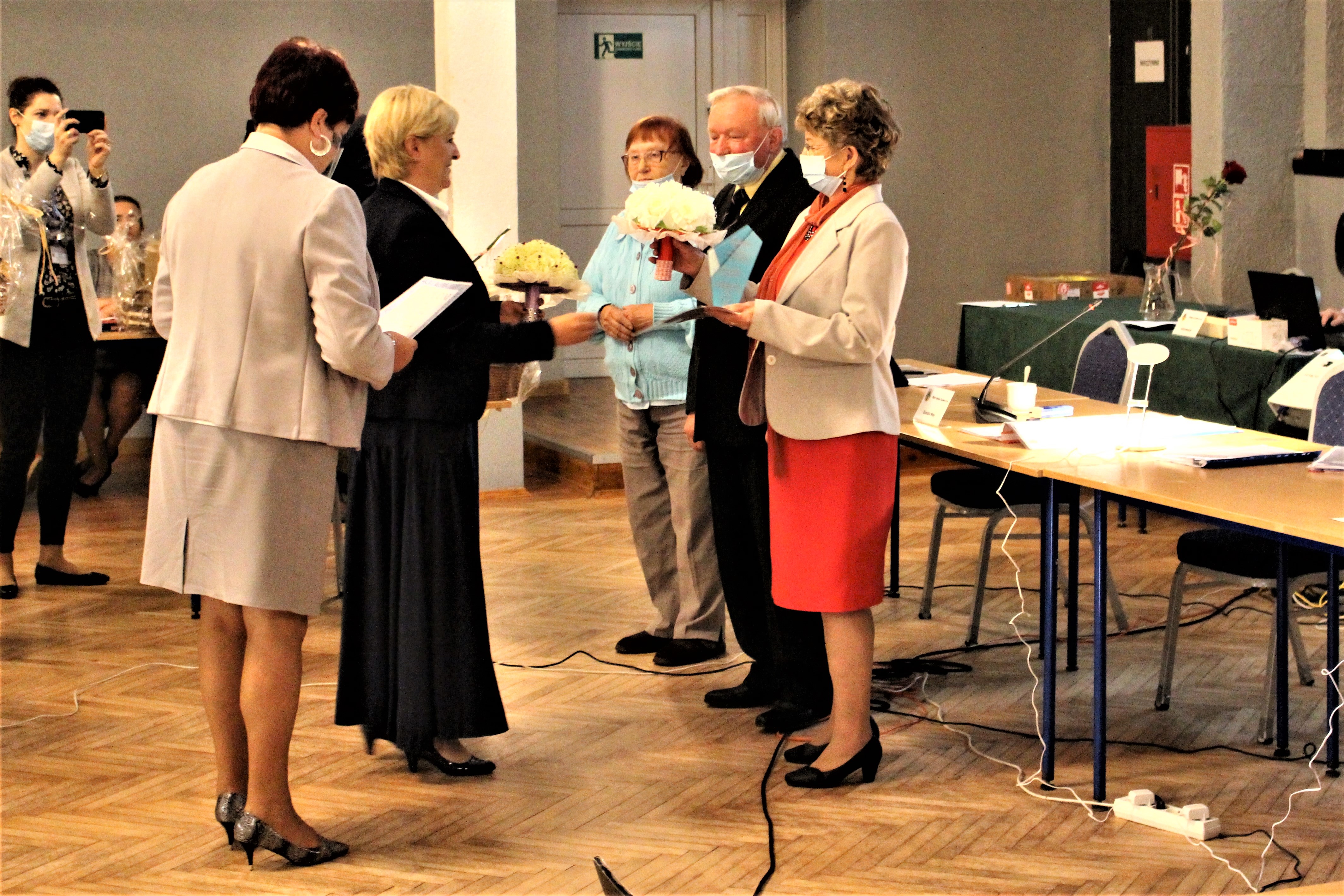 Wójt i sekretarz gminy wręczające nagrody laureatom konkursu